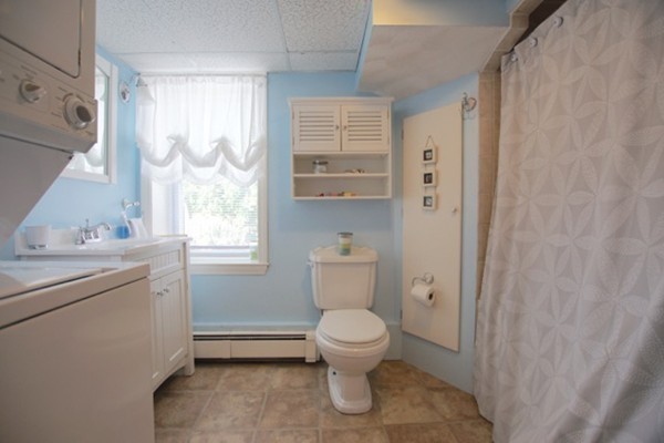 49 Faywood Avenue Boston, MA 02128 - Photo 29 of 30 a bathroom with a granite countertop toilet a sink and a mirror