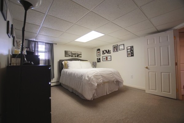 49 Faywood Avenue Boston, MA 02128 - Photo 30 of 30 a spacious bedroom with a bed and a lamp