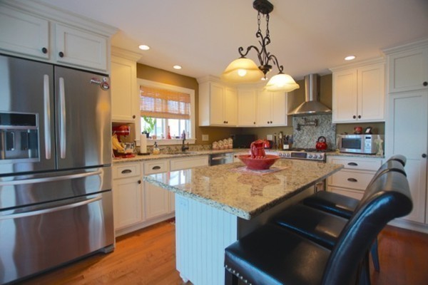 49 Faywood Avenue Boston, MA 02128 - Photo 3 of 30 a kitchen with kitchen island granite countertop a sink appliances and cabinets