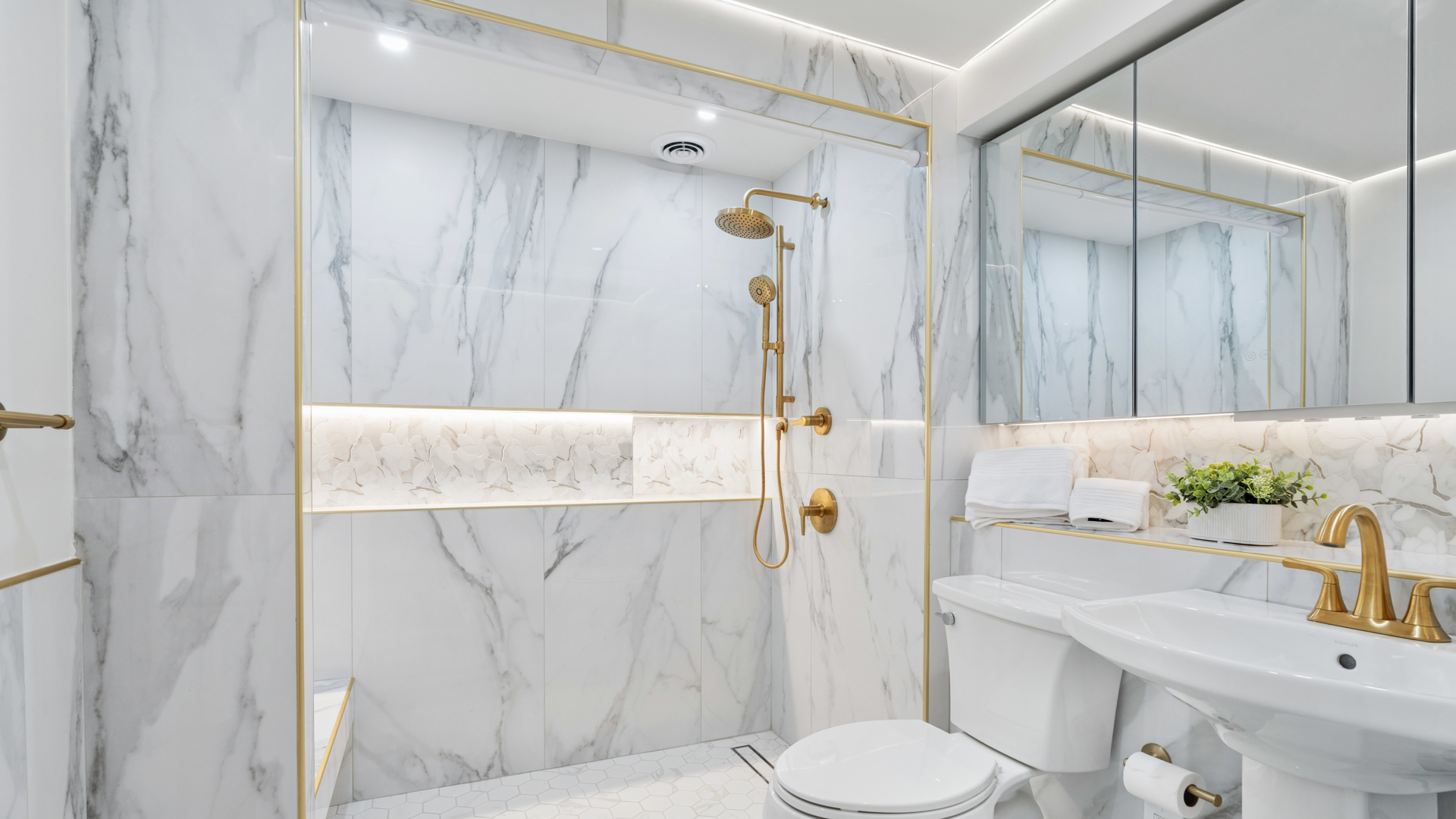 7 East 69th Street Manhattan, NY 10021 - Photo 16 of 27 a bathroom with a sink toilet and shower