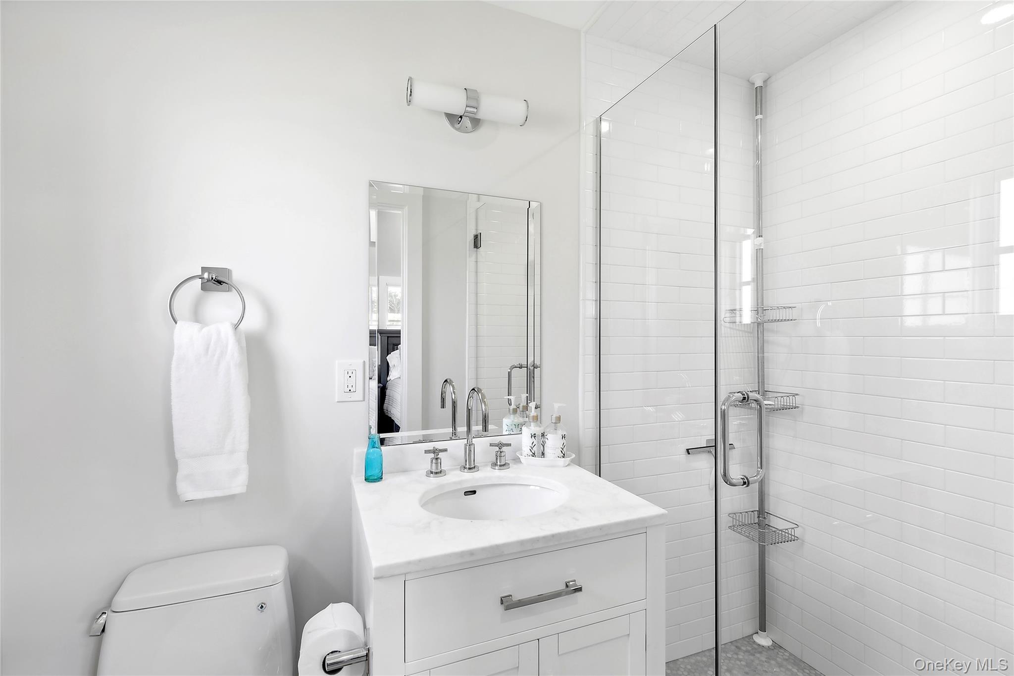 8 Shore Road Remsenburg, NY 11960 - Photo 11 of 21 a bathroom with a sink a toilet and shower