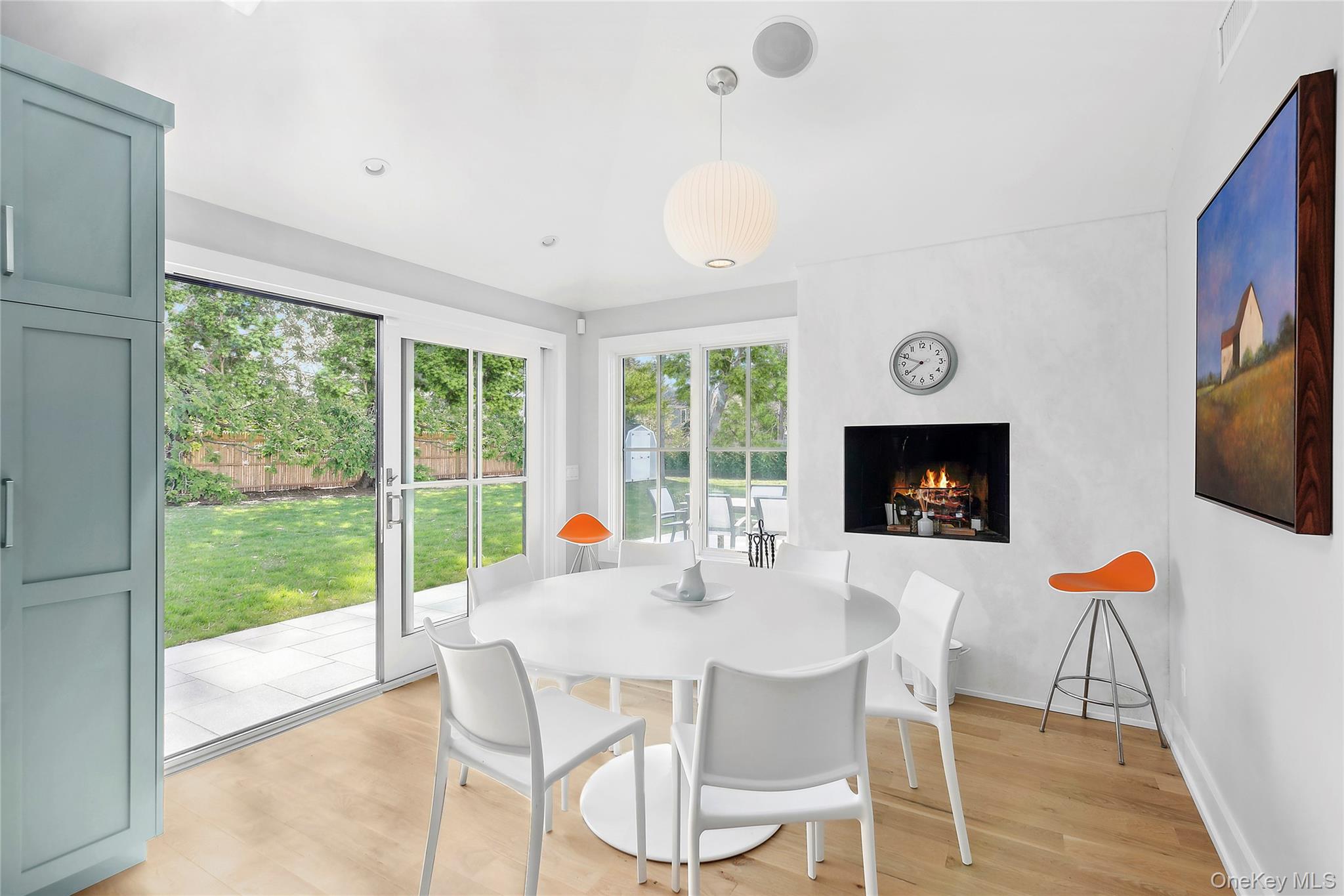 8 Shore Road Remsenburg, NY 11960 - Photo 12 of 21 a dining room with furniture a fireplace and wooden floor