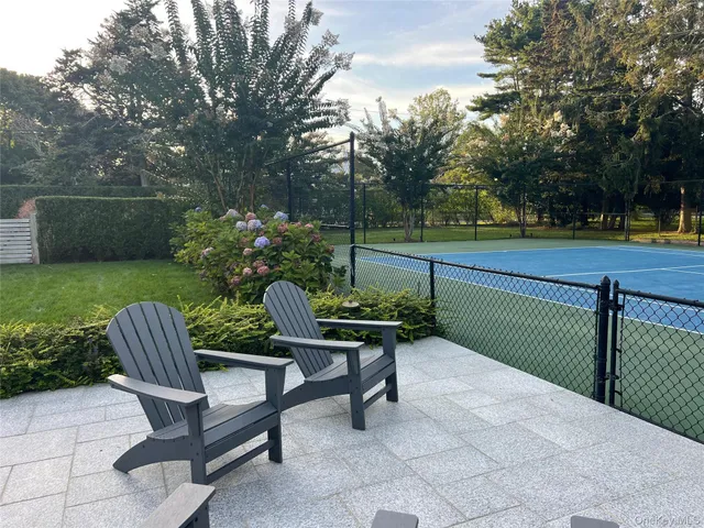 a view of a bench and chairs in the roof deck