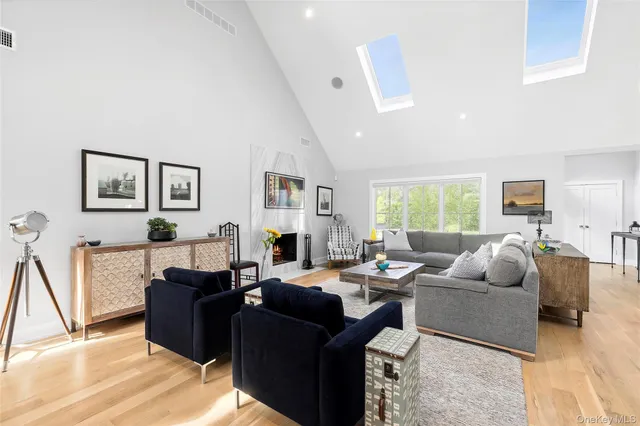 a living room with furniture fireplace and a window