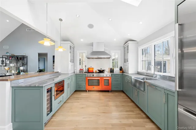 a large kitchen with kitchen island a sink counter top space and stainless steel appliances