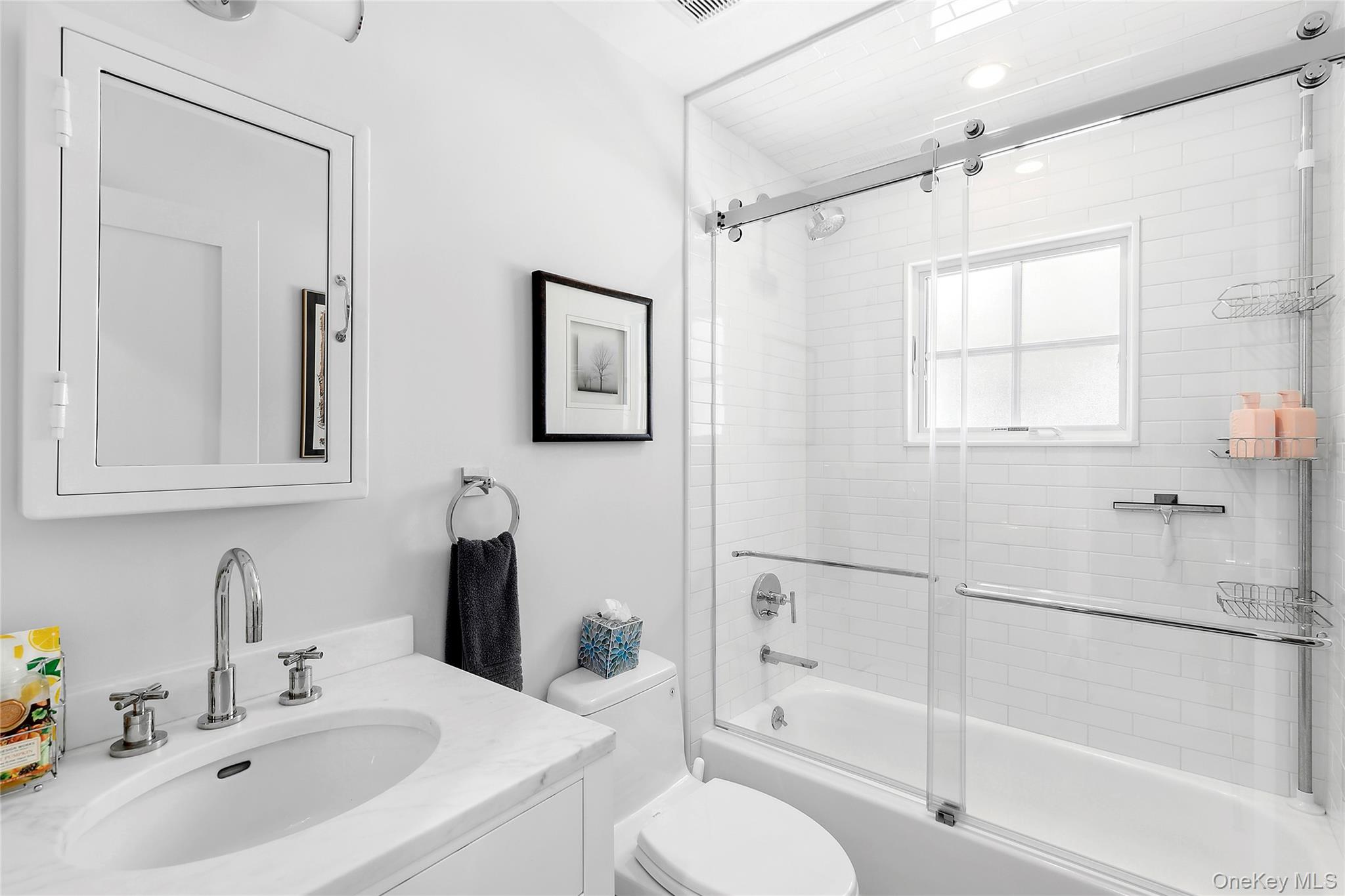 8 Shore Road Remsenburg, NY 11960 - Photo 10 of 21 a bathroom with a sink toilet and shower
