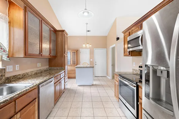a kitchen with stainless steel appliances granite countertop a refrigerator and a sink