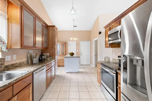 a living room with furniture a fireplace and a large window