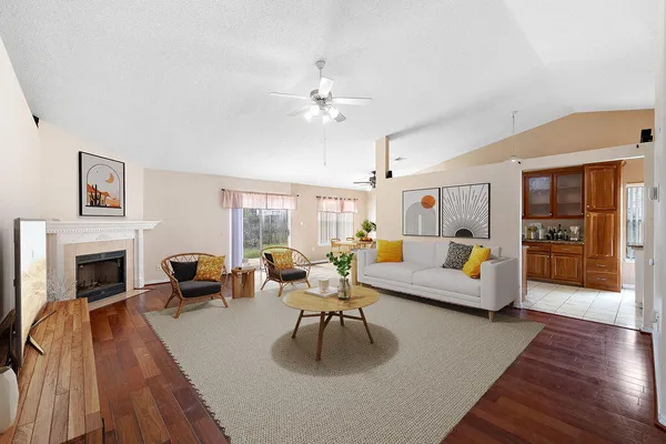 a living room with furniture fireplace and flat screen tv
