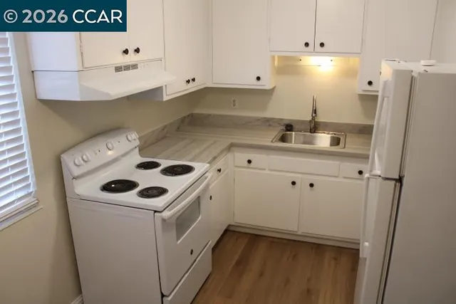 a white refrigerator freezer sitting inside of a kitchen
