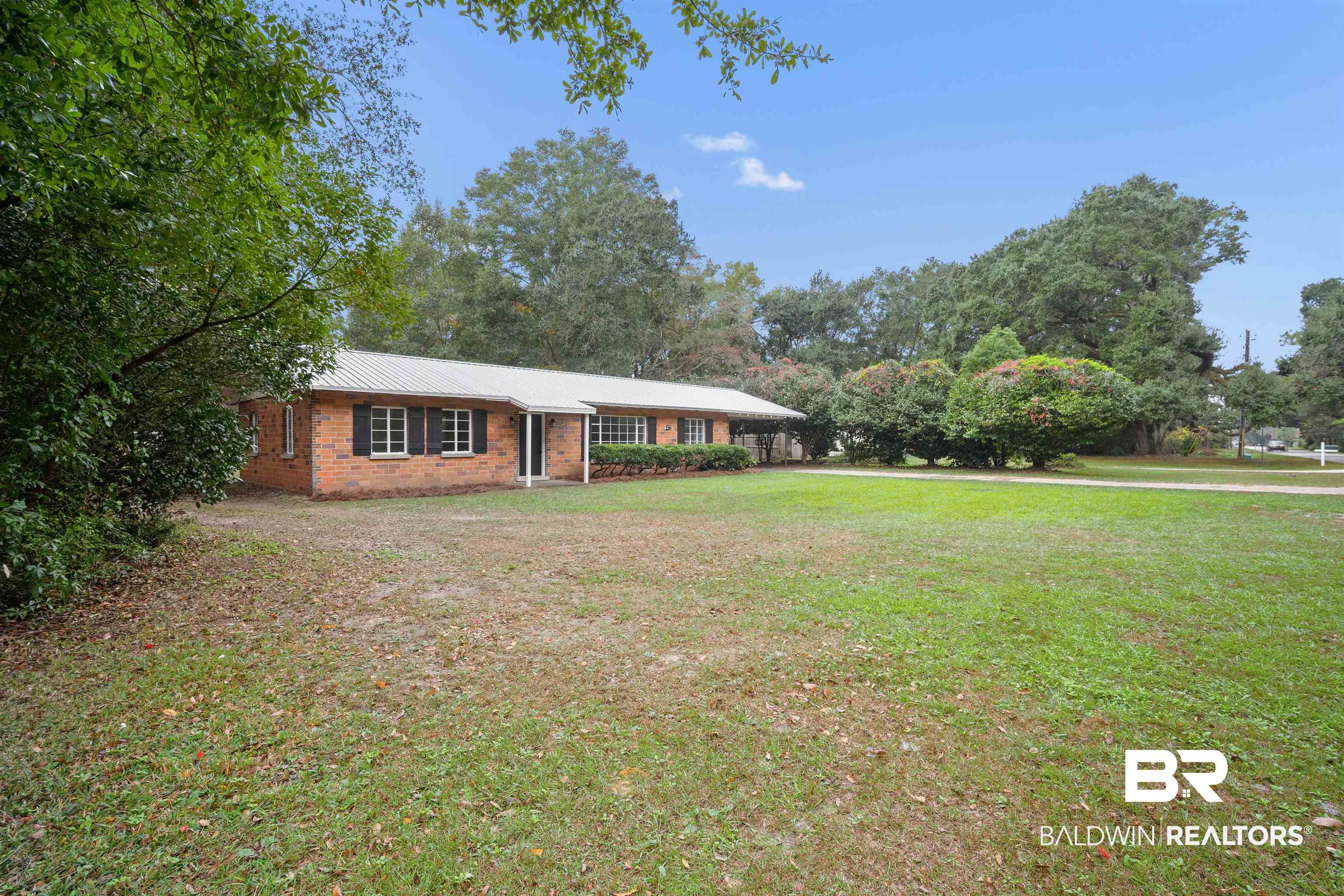2261 Island Road Mobile, AL 36605 - Photo 2 of 25 Ranch-style home with a front lawn and brick siding