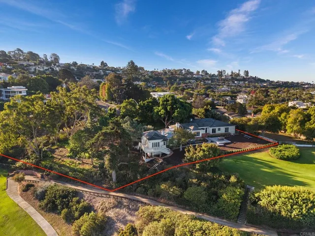 a view of a swimming pool with a yard and plants