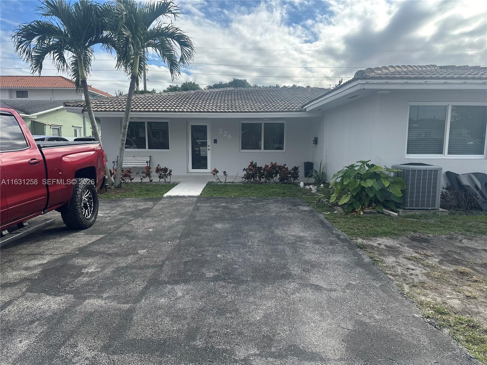 324 East 34th Street Hialeah, FL 33013 - Photo 2 of 37 a view of a house with a backyard