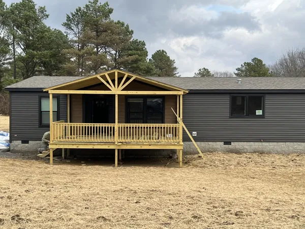 a view of a house with a yard and deck