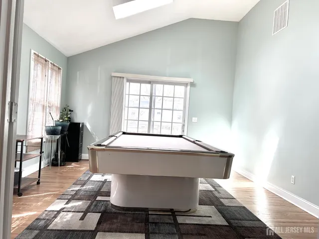 a spacious bathroom with a granite countertop sink a window and a mirror