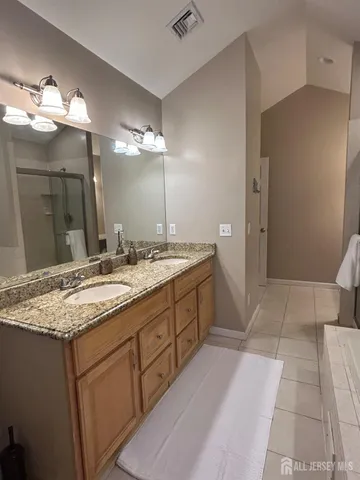 a bathroom with a sink double vanity and a mirror