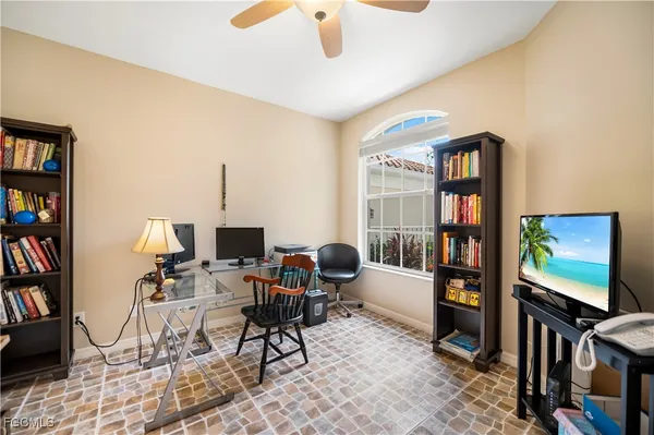a view of a livingroom with workspace and a window