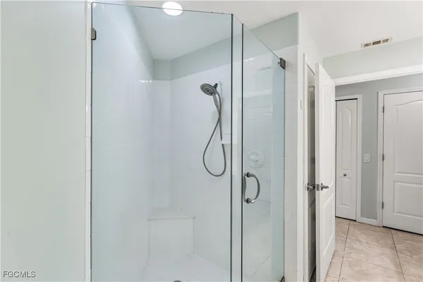 a bathroom with a glass shower door