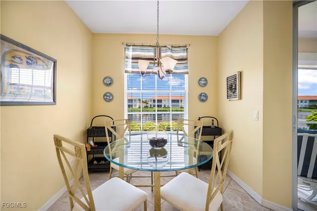 a view of a dining room with furniture a chandelier and wooden floor