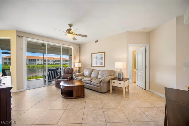 a living room with furniture and a floor to ceiling window