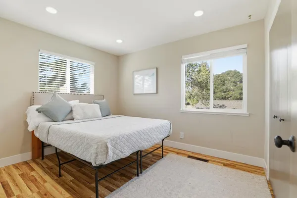 a bedroom with double bed and a wooden floor