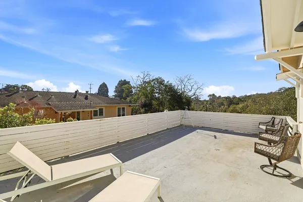 a backyard of a house with yard table and chairs