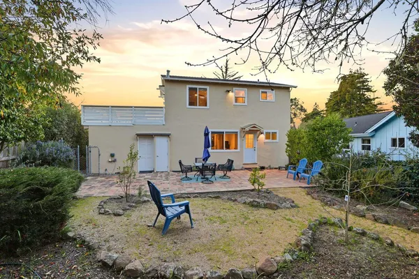 a view of a house with swimming pool and sitting area