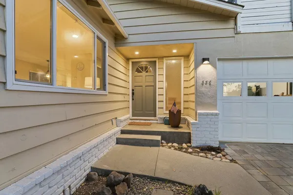 a view of a house with backyard sitting area and fire pit
