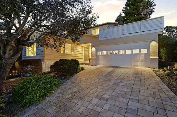 a view of backyard of house with outdoor seating
