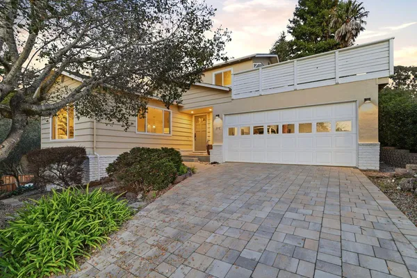 a view of a house with backyard and sitting area