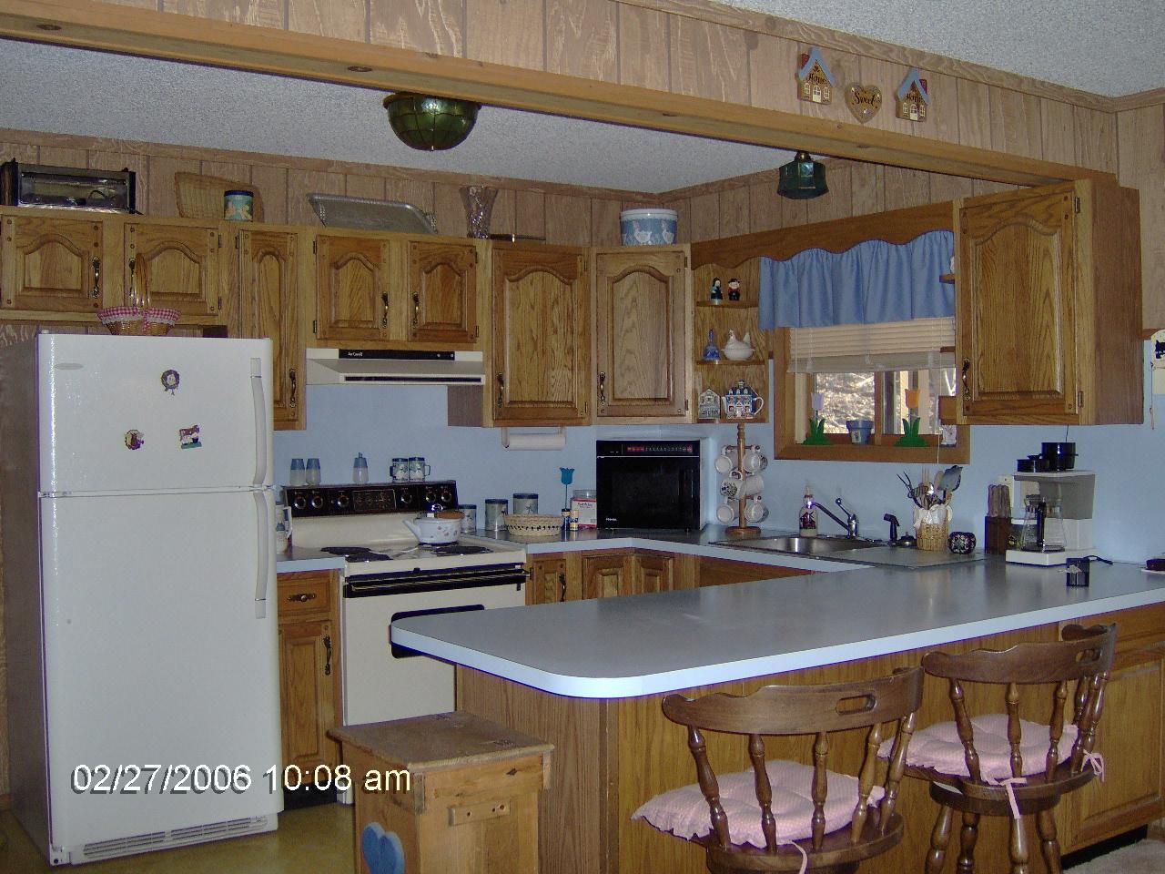1243 Salsibury Road Bushkill, PA 18324 - Photo 2 of 8 a kitchen with stainless steel appliances a sink a stove a refrigerator and cabinets
