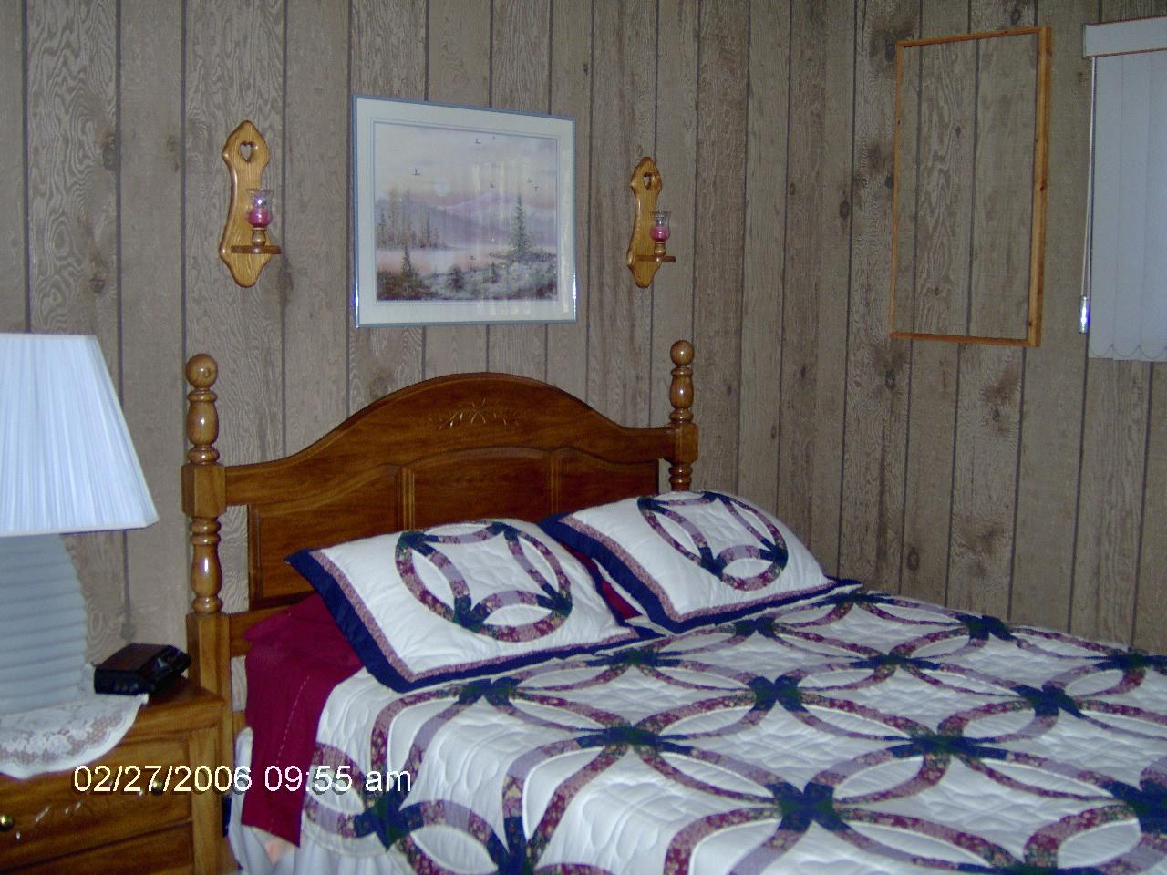 1243 Salsibury Road Bushkill, PA 18324 - Photo 5 of 8 a bedroom with a bed and a painting on the wall