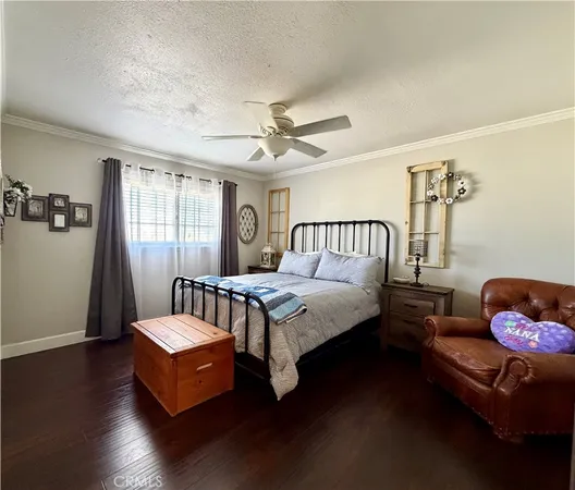 a bedroom with a bed couch and a window