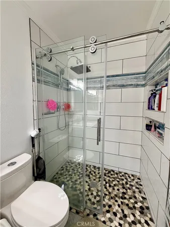 a bathroom with a toilet and shower