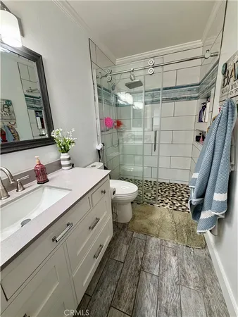 a bathroom with a sink toilet and shower