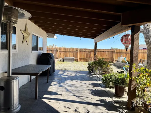a view of a porch with furniture and a yard