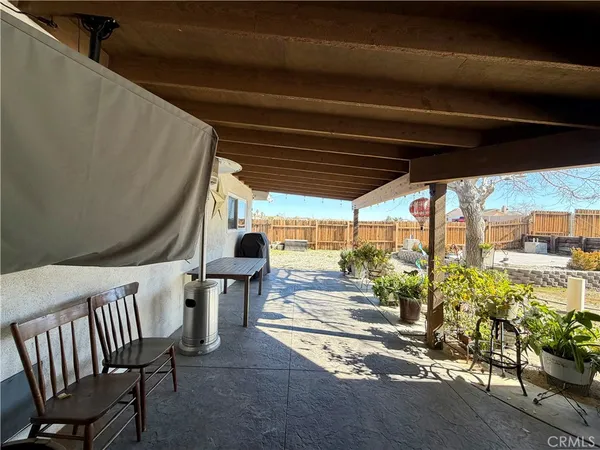 a view of a porch with furniture and a yard