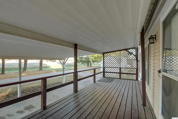 a view of a balcony with wooden floor