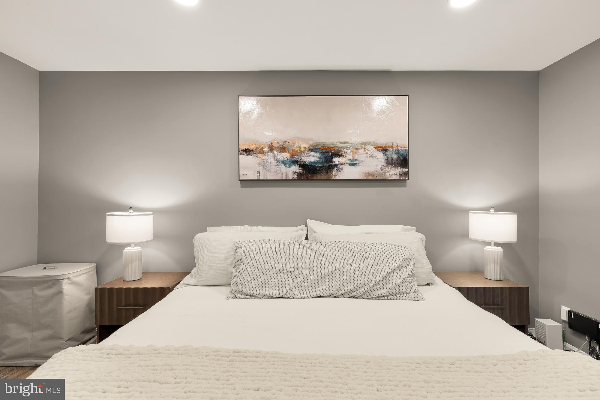 2221 Lovedale Lane, Unit 202B Reston, VA 20191 - Photo 13 of 27 a bedroom with a bed and a painting on the wall