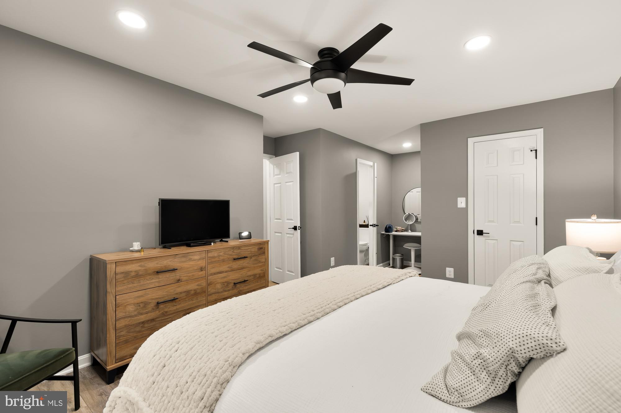 2221 Lovedale Lane, Unit 202B Reston, VA 20191 - Photo 14 of 27 a bedroom with a bed and a flat screen tv