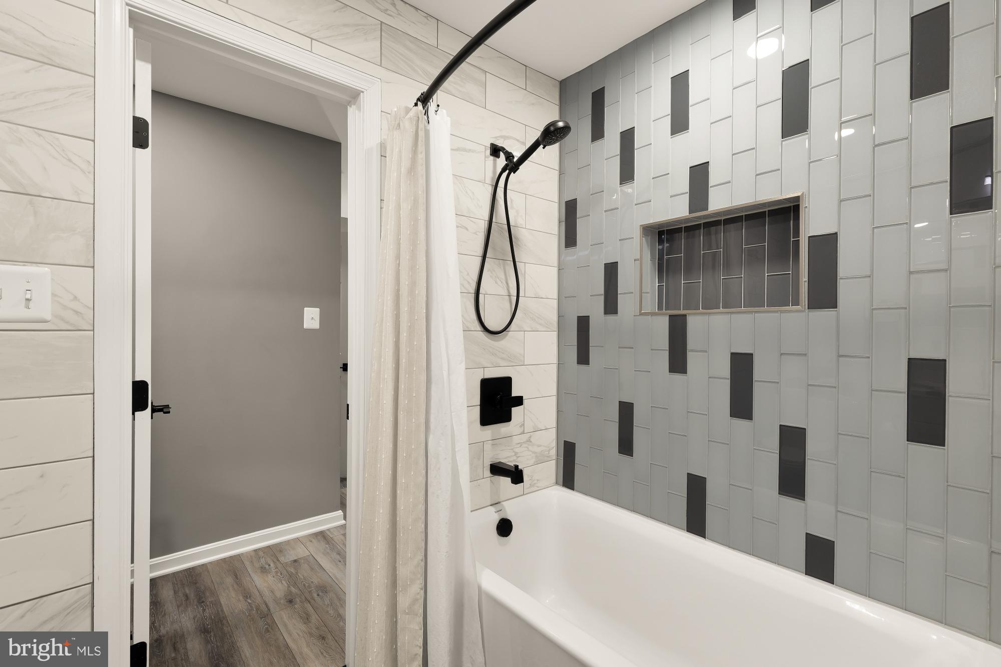 2221 Lovedale Lane, Unit 202B Reston, VA 20191 - Photo 17 of 27 a bathroom with a bathtub and a shower