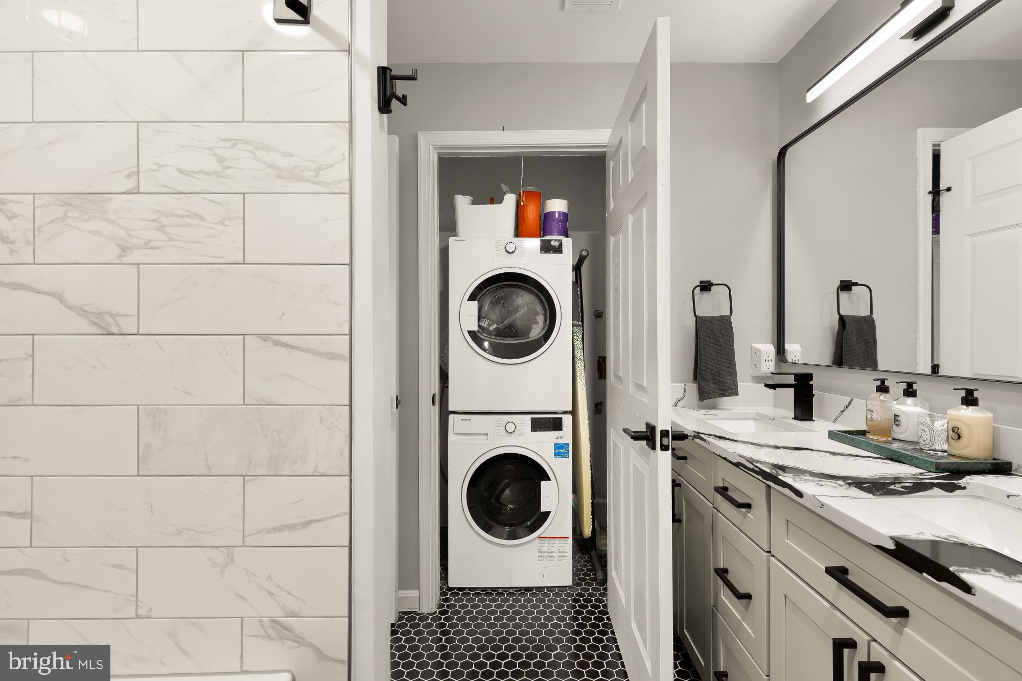 2221 Lovedale Lane, Unit 202B Reston, VA 20191 - Photo 22 of 27 a bathroom with a sink mirror a washer and dryer