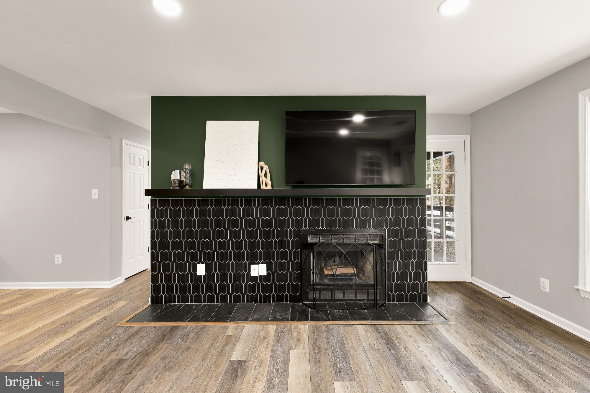 2221 Lovedale Lane, Unit 202B Reston, VA 20191 - Photo 4 of 27 a living room with a fireplace and a wooden floor