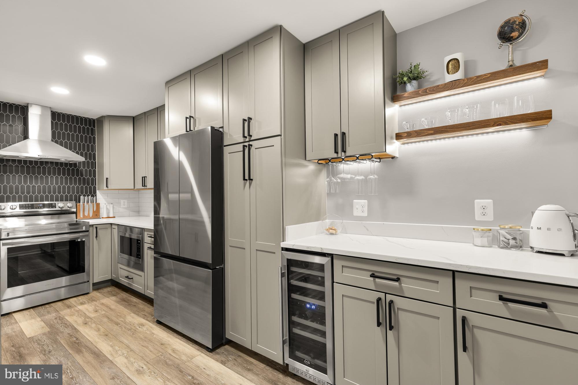 2221 Lovedale Lane, Unit 202B Reston, VA 20191 - Photo 8 of 27 a kitchen with kitchen island granite countertop stainless steel appliances a sink and a refrigerator