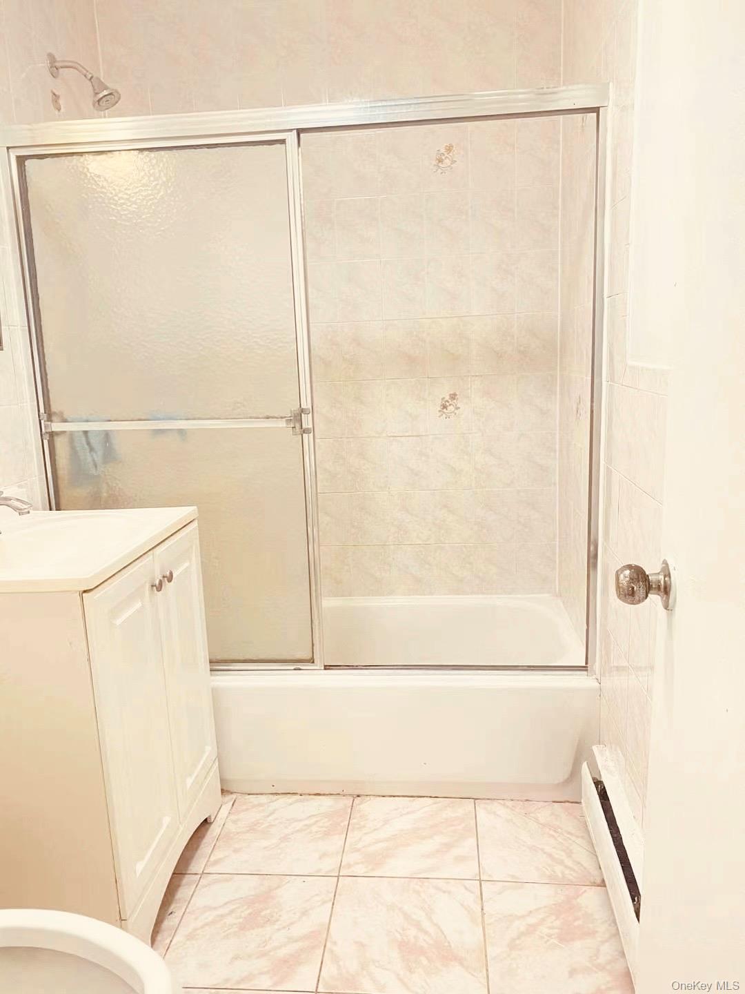 41-08 111th Street Queens, NY 11368 - Photo 9 of 9 a bathroom with a bathtub and a shower