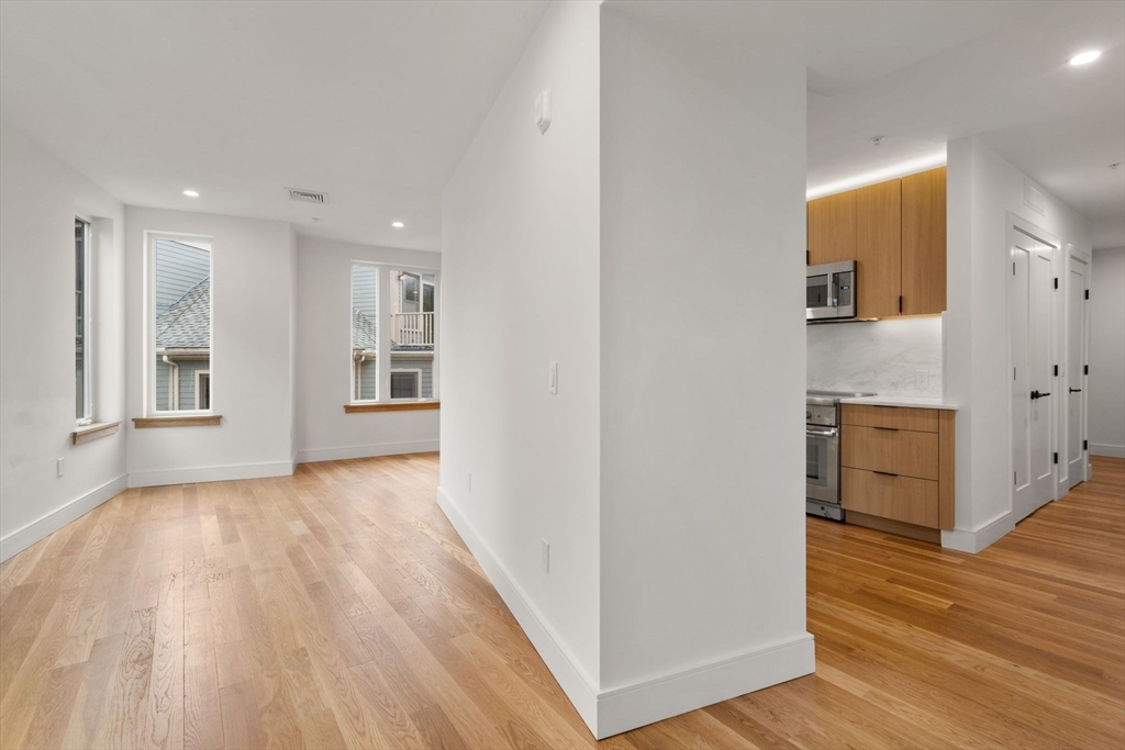 58 Kent, Unit 304 Brookline, MA 02445 - Photo 10 of 19 a view of a kitchen with wooden floor and a sink