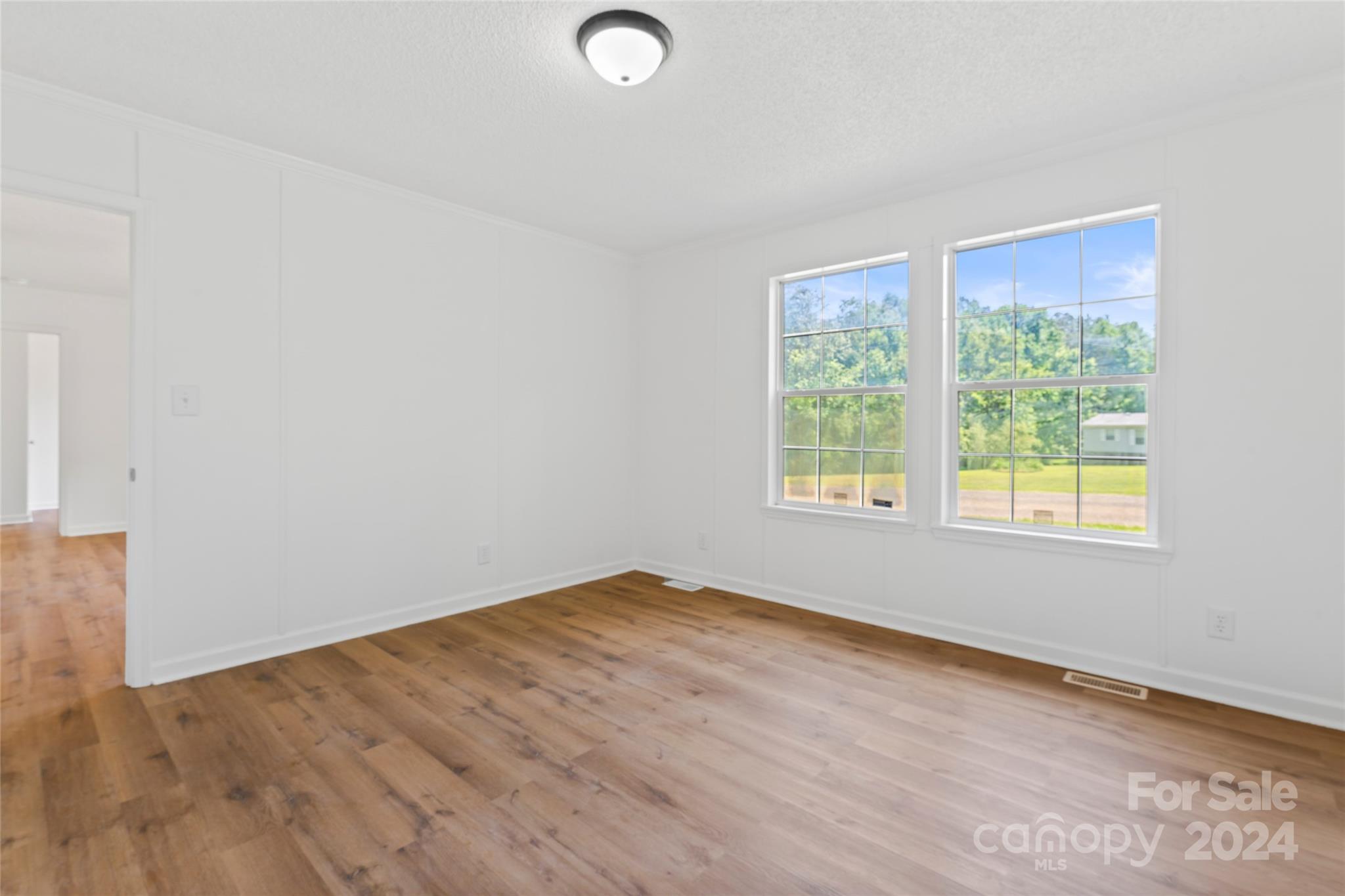 669 Ross Road Lincolnton, NC 28092 - Photo 12 of 30 a view of an empty room with wooden floor and a window