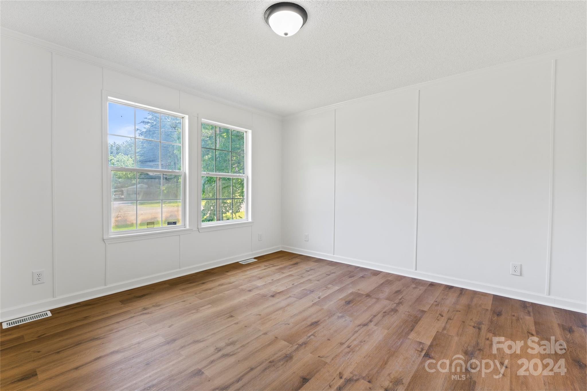 669 Ross Road Lincolnton, NC 28092 - Photo 9 of 30 an empty room with wooden floor and windows