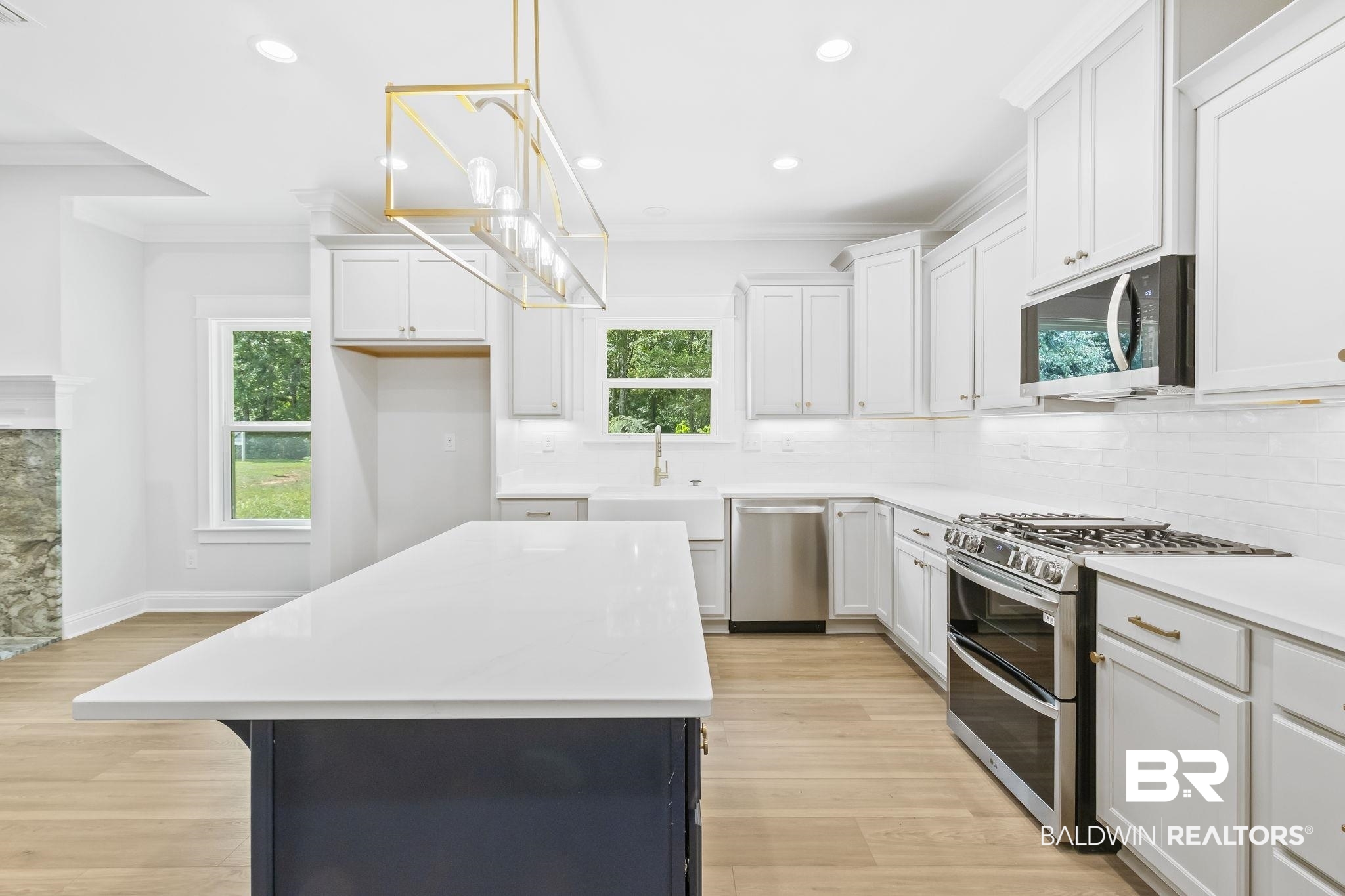 12130 Reunion Place Foley, AL 36535 - Photo 14 of 42 Kitchen featuring white cabinets, stainless steel appliances, and light wood-type flooring