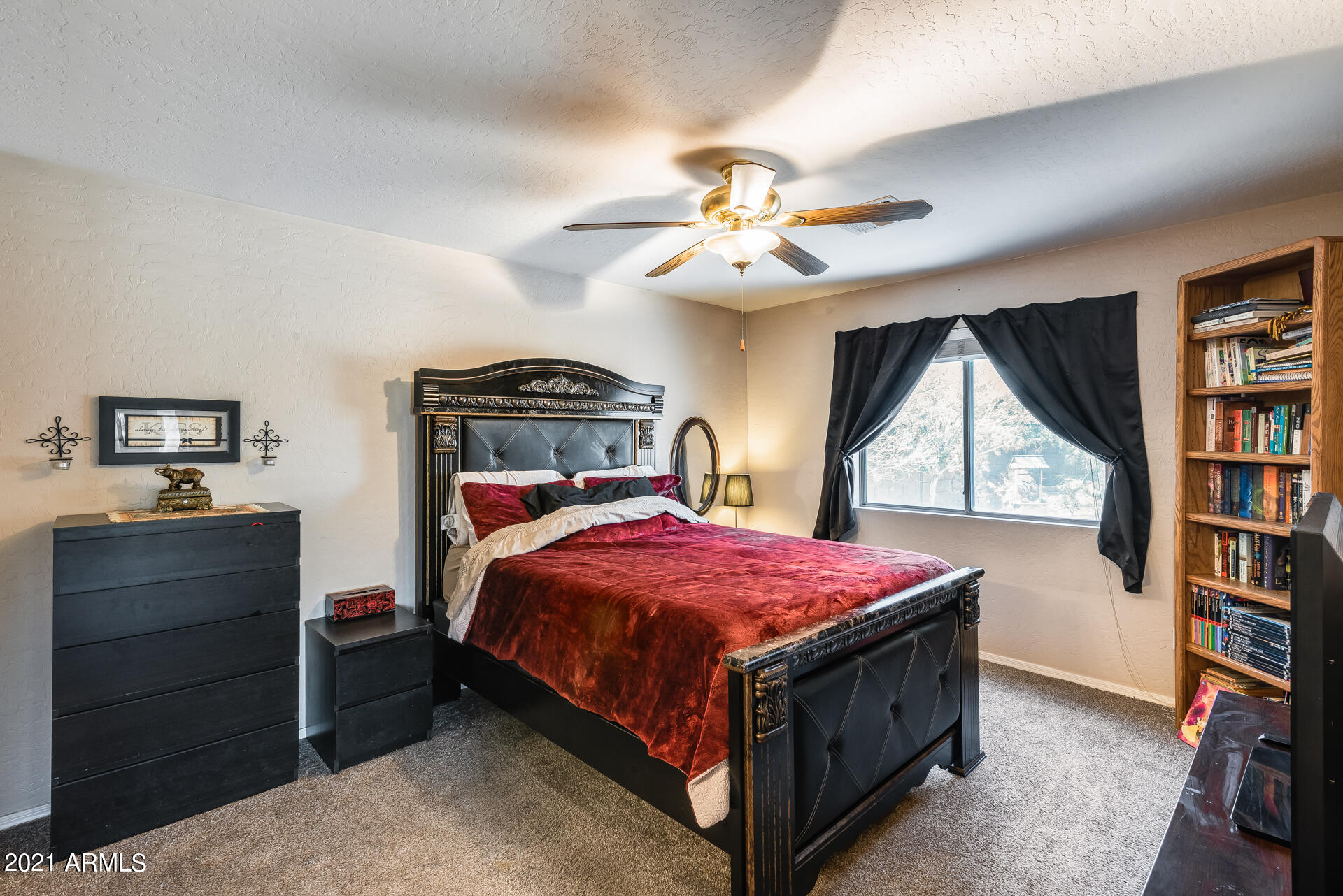 15037 West Calavar Road Surprise, AZ 85379 - Photo 24 of 28 a bedroom with a bed and a book shelf